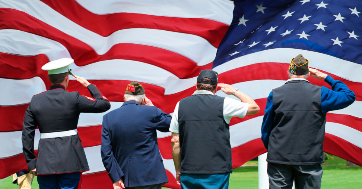 VA Funding Cut: What Are Its Implications for Veterans? - top government contractors Soldiers and veterans saluting in front of the American flag