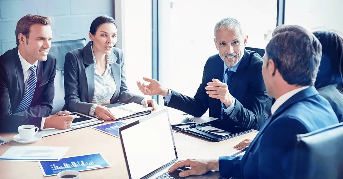 8(a) Business Development Program: What Is It and How Does It Work? - top government contractors A small business team in a meeting to discuss 8(a) Business Development Program